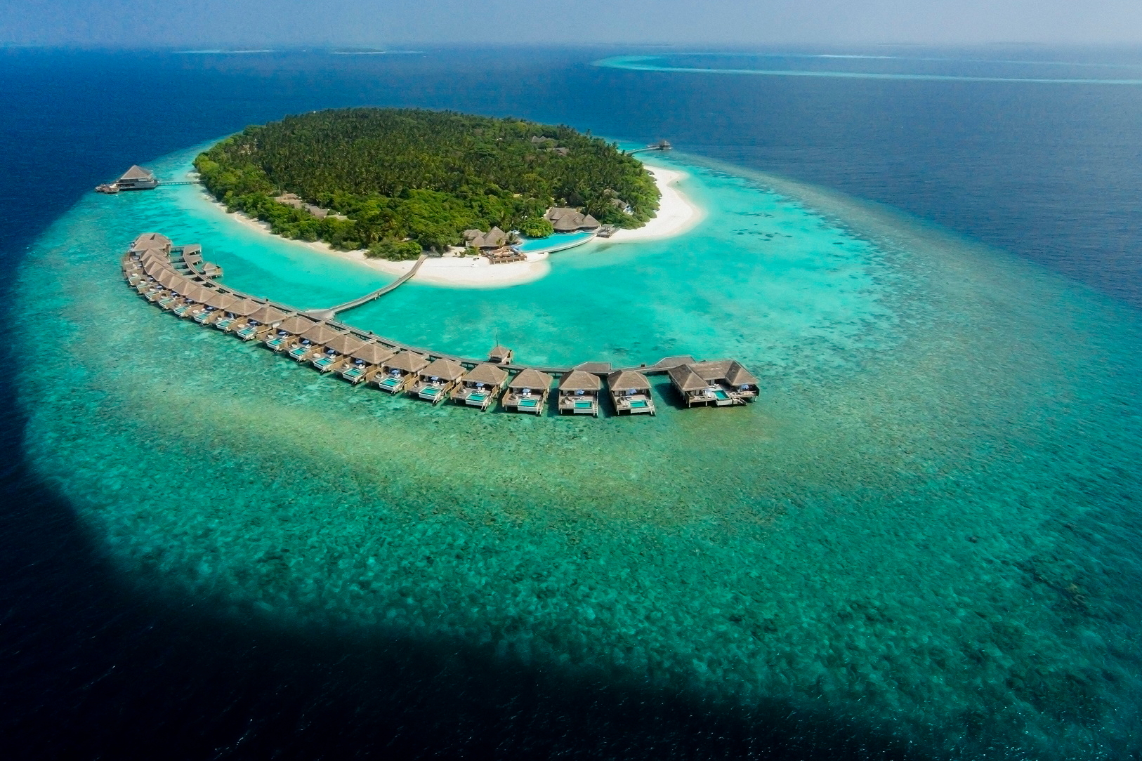 The Dusit Thani Maldives is a luxury Thai-inspired resort on Mudhdhoo Island in Baa Atoll. It is just 35 minutes by seaplane from Malé, or a 25-minute domestic flight and 10 minutes by speedboat from Dharavandhoo Airport. Click to enlarge.