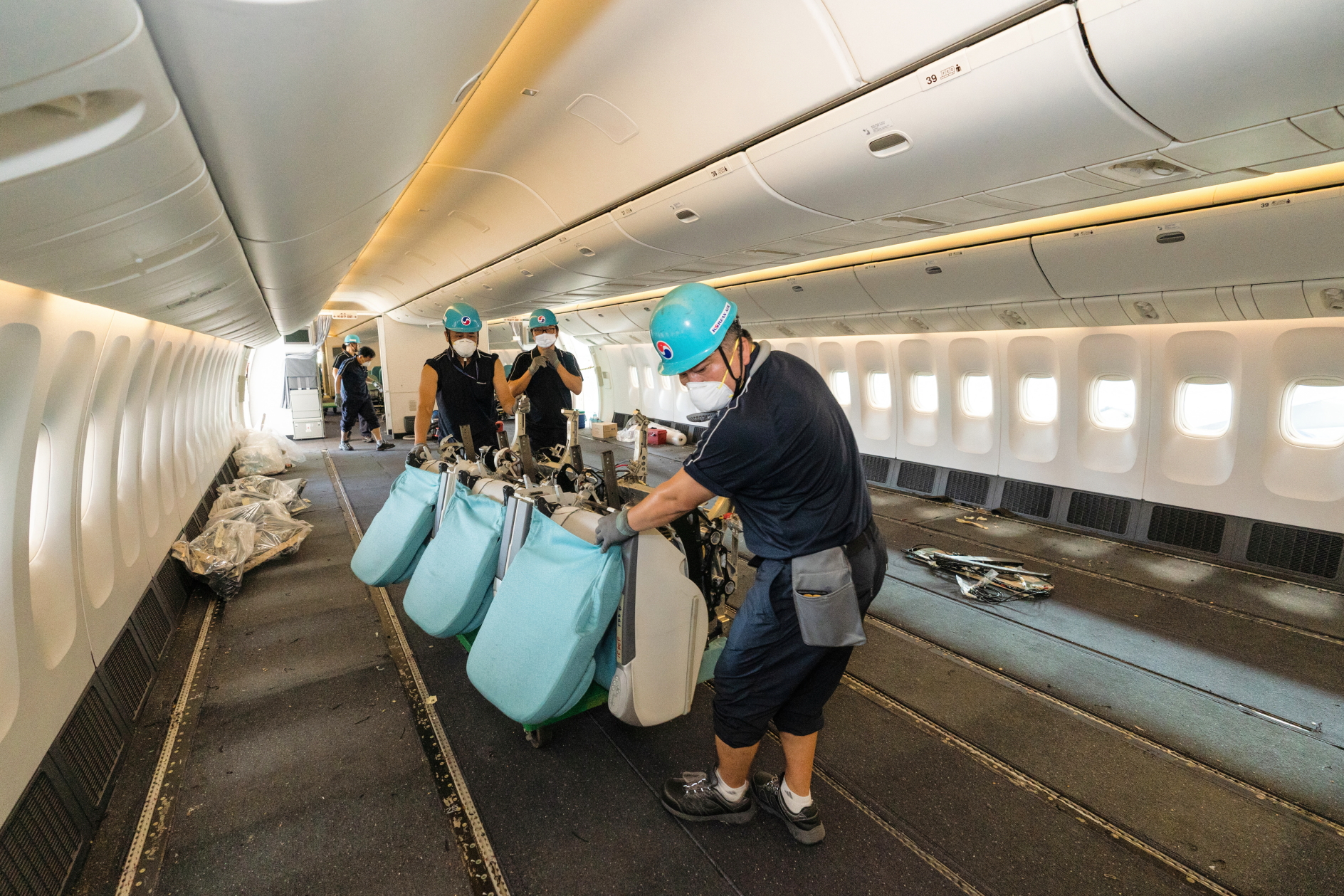 Removing the seats out of a Korean Air Boeing 777-300ER so that the aircraft can be used for cargo-only flights. Click to enlarge.