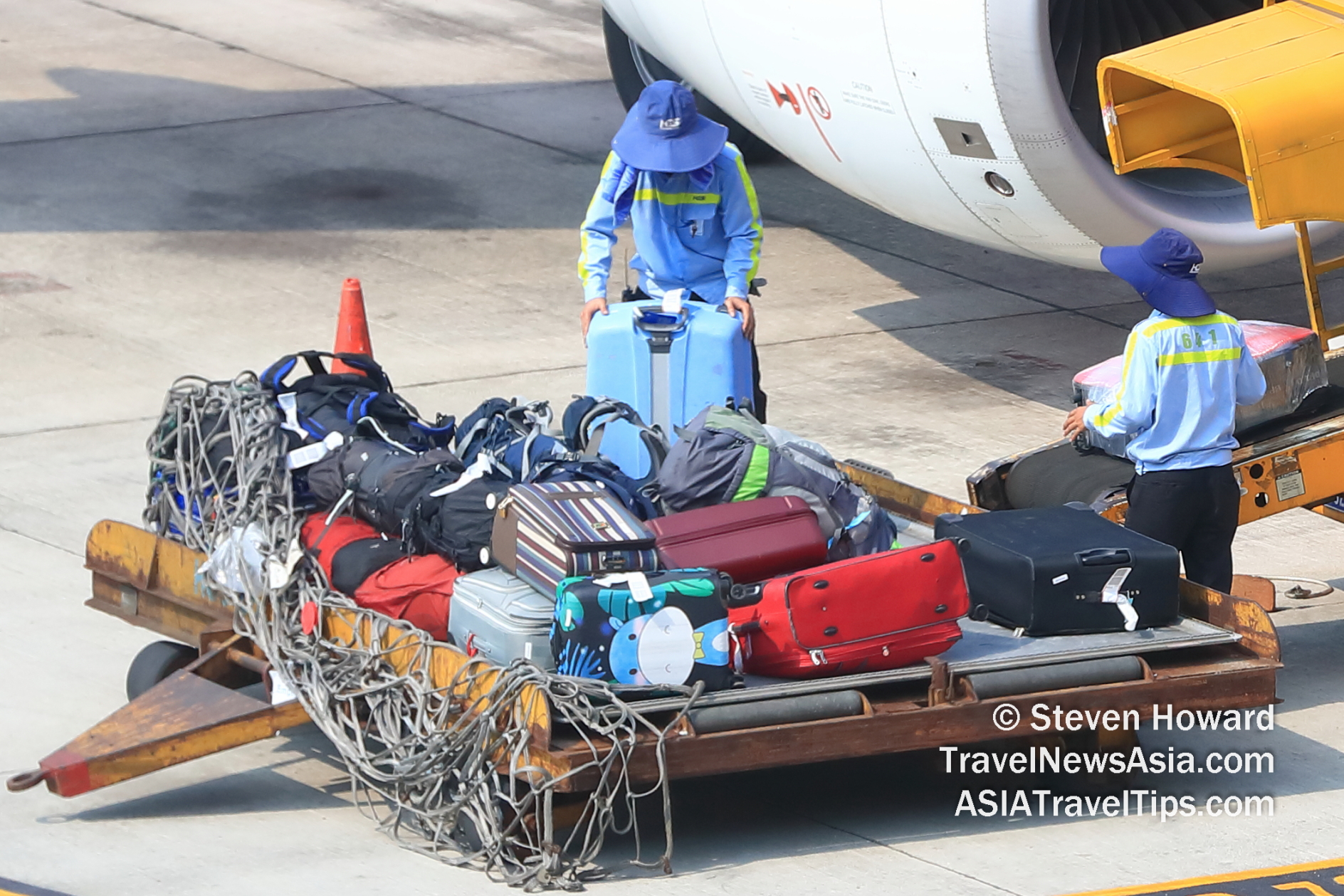 Baggage being loaded onto a plane. Picture by Steven Howard of TravelNewsAsia.com Click to enlarge.