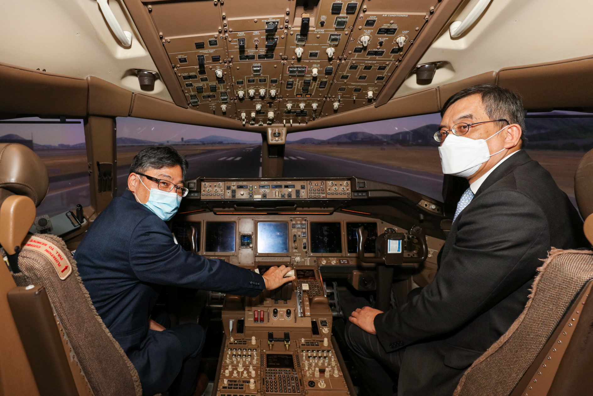 Lam Sai-hung (left), Secretary for Transport and Logistics, in a flight simulator with Augustus Tang, Cathay Pacific's CEO. Click to enlarge.