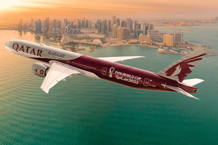 Qatar Airways B777 reg: A7-BEB with FIFA World Cup 2022 livery and Doha in the background. Click to enlarge.