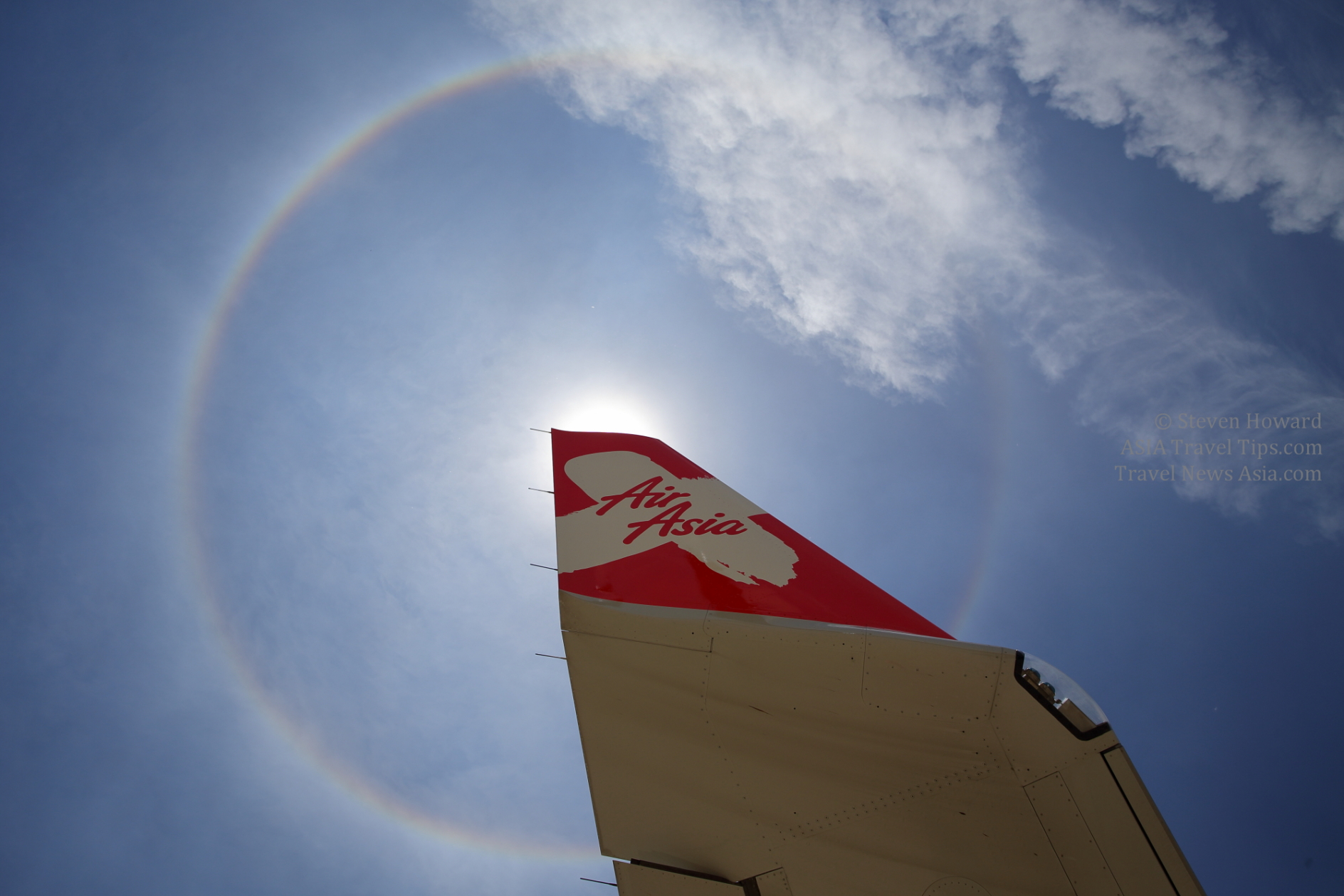 Wingtip of an AirAsia X A330 with sunbow in the sky above. Picture by Steven Howard of TravelNewsAsia.com Click to enlarge.