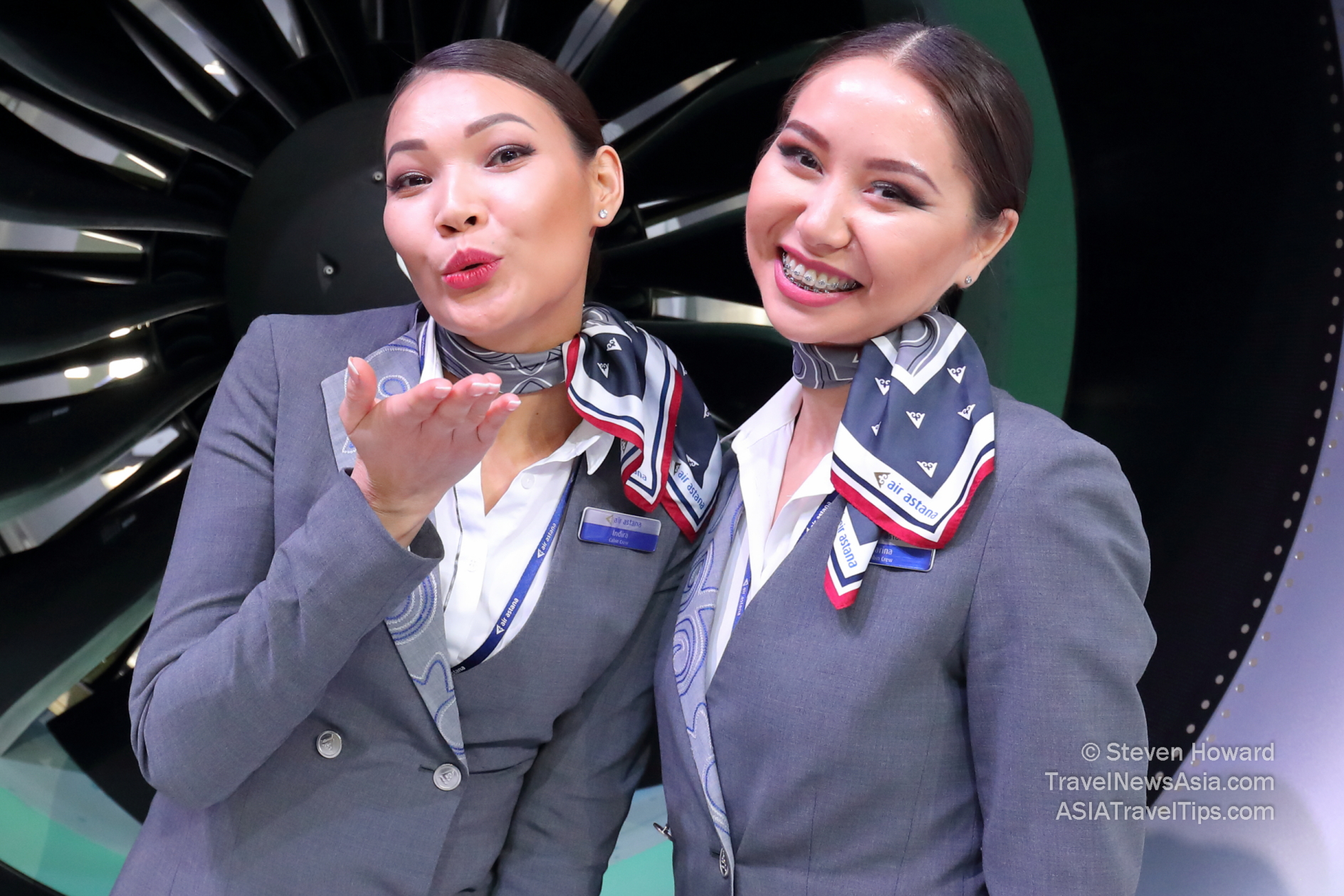 Two beautiful Air Astana employees posing for the camera. Picture by Steven Howard of TravelNewsAsia.com Click to enlarge.