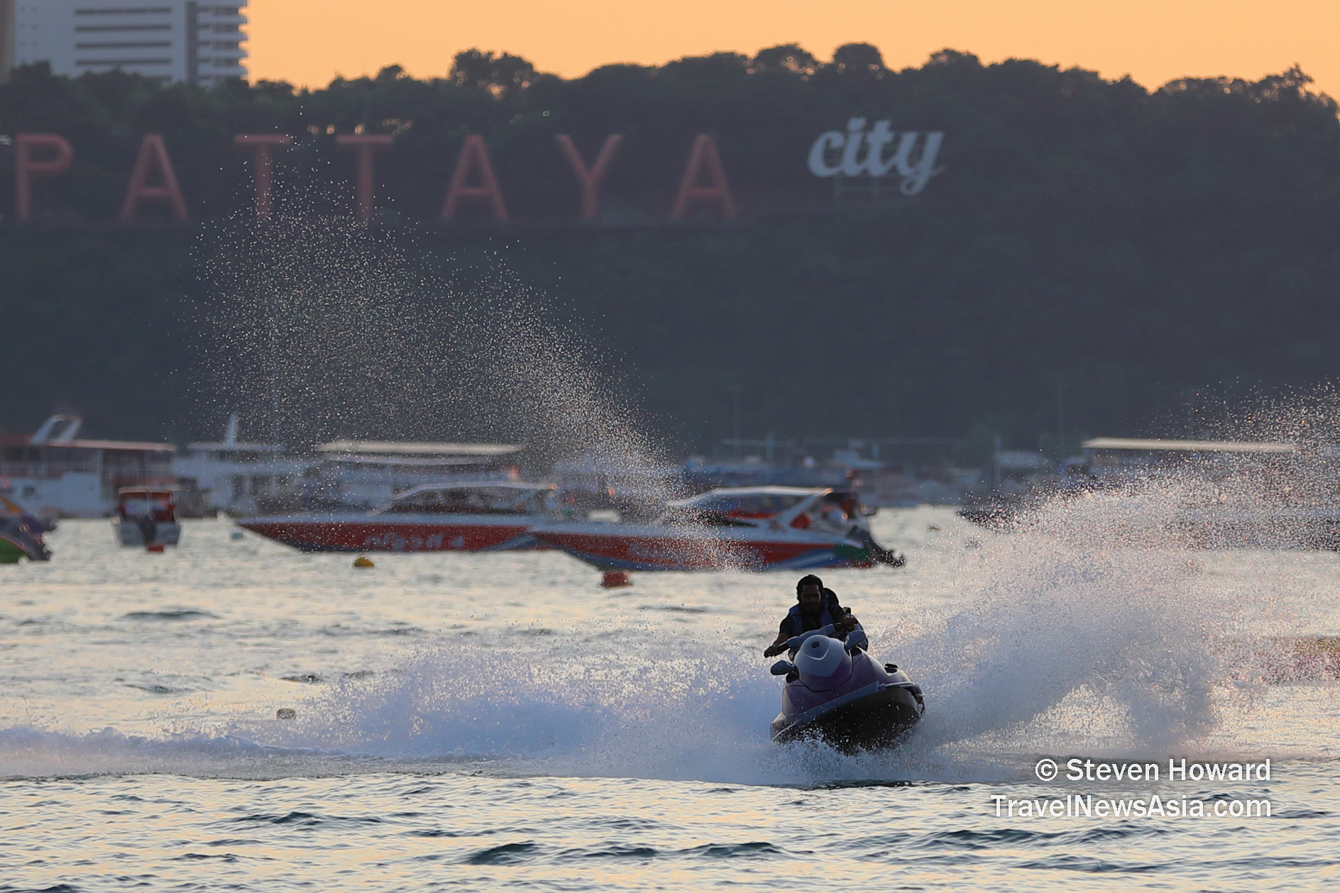 Tourists having fun on a jetski in Pattaya, Thailand. Picture by Steven Howard of TravelNewsAsia.com Click to enlarge.